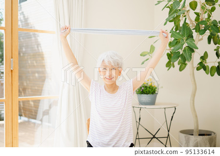 Senior woman stretching with a towel 95133614