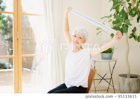 Senior woman stretching with a towel Senior woman stretching with a towel 95133615