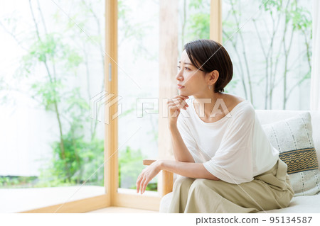 Housewife thinking in the living room 95134587