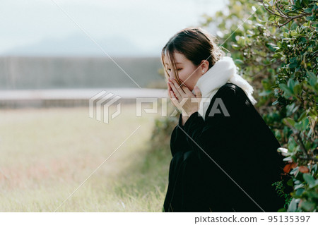 Photo of a woman wearing a scarf Photo of a woman wearing a scarf 95135397