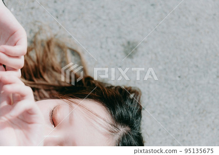 Photo of a woman standing by the sea Photo of a woman standing by the sea 95135675