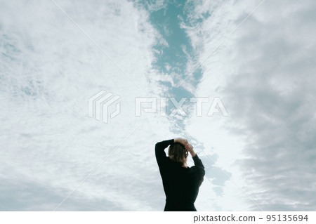 Photo of a woman standing by the sea 95135694