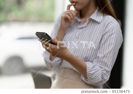 A businesswoman completes KYC using an online banking program in order to open a digital savings account. The definition of cyber security A businesswoman completes KYC using an online banking program in order to open a digital savings account. The definition of cyber security 95136473