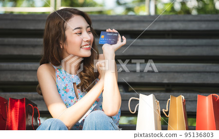 Young asian shopaholic woman hold credit card for cashless 95136803