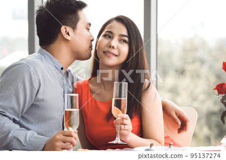 Adult asian lover couple man and woman hand hold a champagne. Adult asian lover couple man and woman hand hold a champagne. 95137274