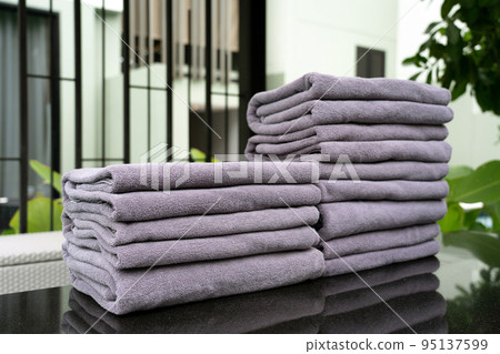 Grey rolled towels on a counter for customer service at hotel, spa, swimming pool or sport club Grey rolled towels on a counter for customer service at hotel, spa, swimming pool or sport club 95137599