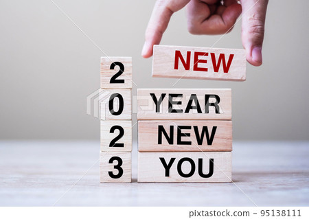 hand holding wooden block with text 2023 NEW YEAR NEW YOU on table background. Resolution, strategy, goal, business and holiday concepts hand holding wooden block with text 2023 NEW YEAR NEW YOU on table background. Resolution, strategy, goal, business and holiday concepts 95138111