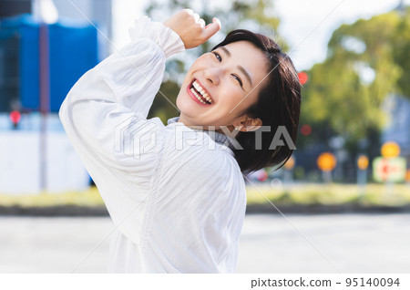 Smiling woman portrait outdoors 95140094