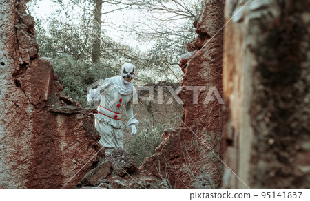 evil clown in motion in a ruined old house evil clown in motion in a ruined old house 95141837