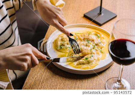 young woman eating tasty ravioli in cafe young woman eating tasty ravioli in cafe 95143572