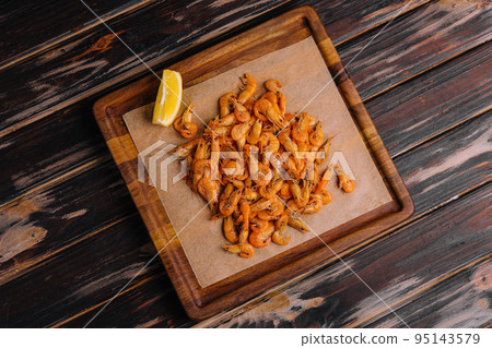 Small cooked shrimp on wooden tray Small cooked shrimp on wooden tray 95143579