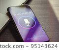 Voice search, speech recognition and sound detect app concept with close up smartphone lying on a black wooden table 95143624