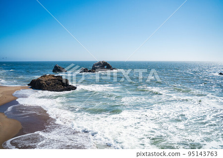 Rocks with heart shape and ocean waves on a beach on a bright sunny day. Travelling in the usa NoCal California Gulf of the Farallones Nature travel landscape background 95143763