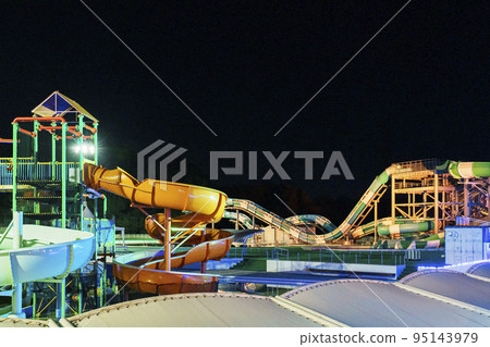 An empty waterslide lit up 95143979