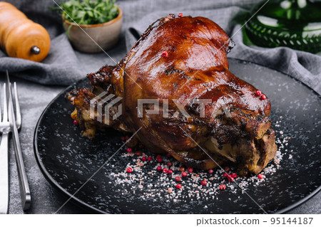 Roast pork knuckle on black plate Roast pork knuckle on black plate 95144187