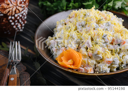 Fresh salad olivier in a ceramic bowl Fresh salad olivier in a ceramic bowl 95144198