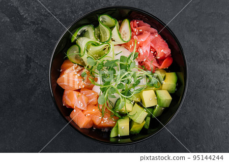 A bowl of salmon poke with avocado A bowl of salmon poke with avocado 95144244