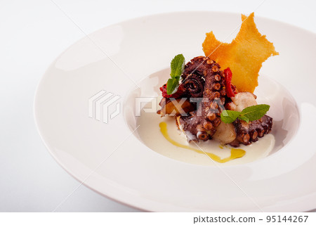 Grilled octopus on plate on white Grilled octopus on plate on white 95144267