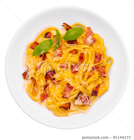 Pasta with bacon and basil on white plate 95144273