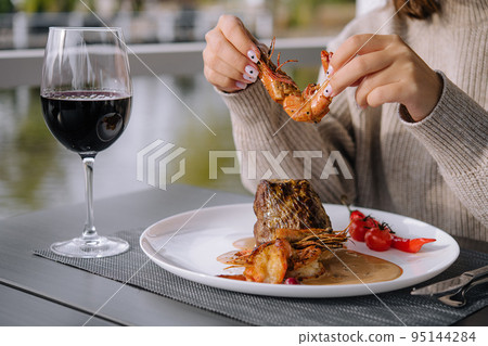 Filet mignon with shrimps and glass of wine 95144284