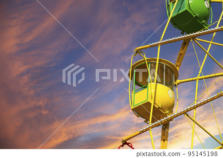 Attraction (carousel) ferris wheel against the background of a romantic evening sky 95145198