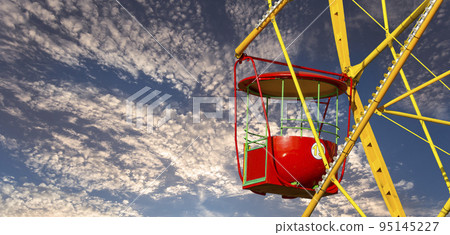 Attraction (carousel) ferris wheel against the background of a romantic evening sky 95145227
