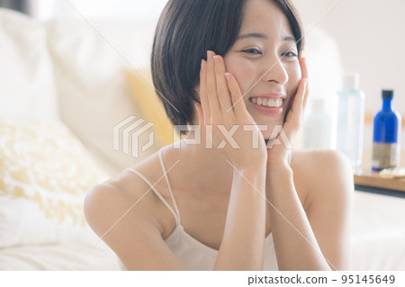 Woman applying lotion/skin care image 95145649