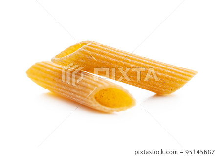 Uncooked whole grain pasta isolated on white background. Raw penne pasta. Uncooked whole grain pasta isolated on white background. Raw penne pasta. 95145687