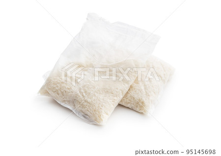 Uncooked rice in cooking sack isolated on white background. 95145698
