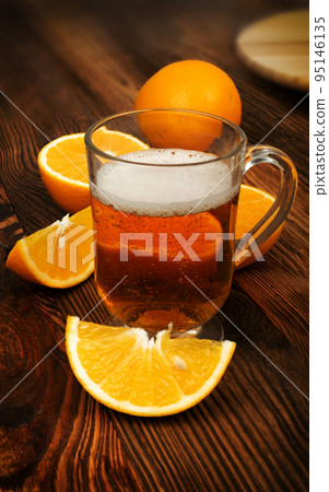 Glass of Orange Citrus Craft Beer with Fresh Fruits 95146135