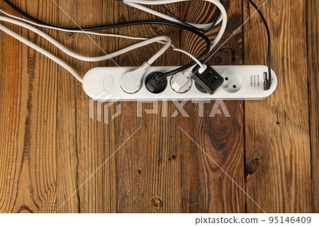 Power Strip, Extension Cable on Wooden Background Power Strip, Extension Cable on Wooden Background 95146409