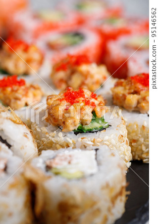 Traditional japanese sushi roll with tuna, tobiko red caviar and cucumber. 95146562