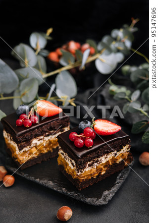 Delicious chocolate cake decorated with fresh berries Delicious chocolate cake decorated with fresh berries 95147696