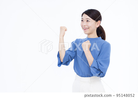 Business woman in her thirties doing a guts pose Business woman in her thirties doing a guts pose 95148052