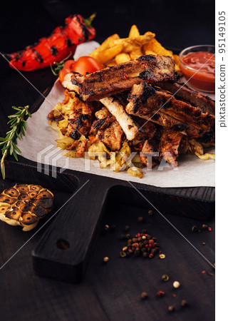 Close up gourmet main dish with grilled pork rib and fried potatoes Close up gourmet main dish with grilled pork rib and fried potatoes 95149105