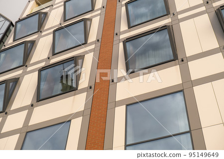 Modern buildings on Granary Island over the Motlawa River in Old Town. Abstract structure. Creative photo Tourism on the Motlawa River. New Apartments architecture glass windows with reflections 95149649