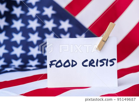 The National Flag of USA. American Flag and paper note message text FOOD CRISIS. global hunger, inflation, high prices, increasing living expenses and poverty, financial crisis, food supply issue The National Flag of USA. American Flag and paper note message text FOOD CRISIS. global hunger, inflation, high prices, increasing living expenses and poverty, financial crisis, food supply issue 95149687