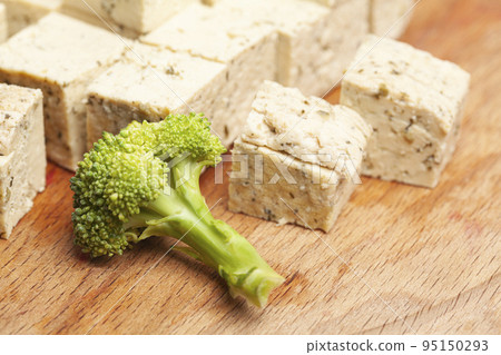 tofu cheese with broccoli on the cutting board 95150293