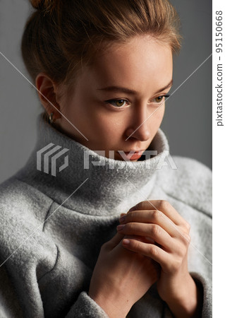 Portrait fashion model woman gray coat style pose on color background in studio 95150668