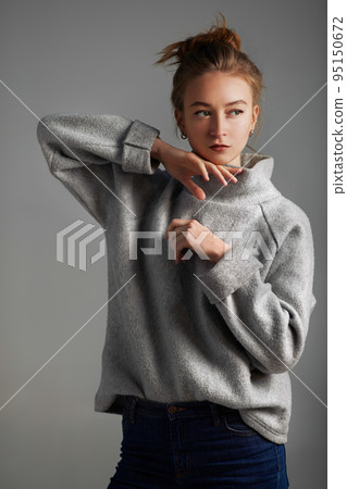 Portrait fashion model woman gray coat style pose on color background in studio Portrait fashion model woman gray coat style pose on color background in studio 95150672