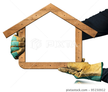 Gloved Hands Holding an Empty Wooden Frame in the Shape of a House 95150912