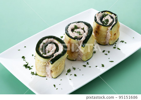 Grilled zucchini rolls stuffed with cream cheese and tuna Grilled zucchini rolls stuffed with cream cheese and tuna 95151686
