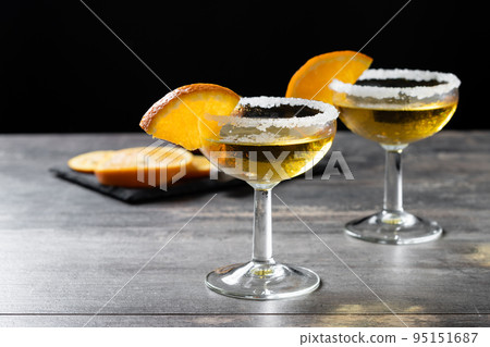 Sidecar cocktail with a sugar rim on wooden table Sidecar cocktail with a sugar rim on wooden table 95151687