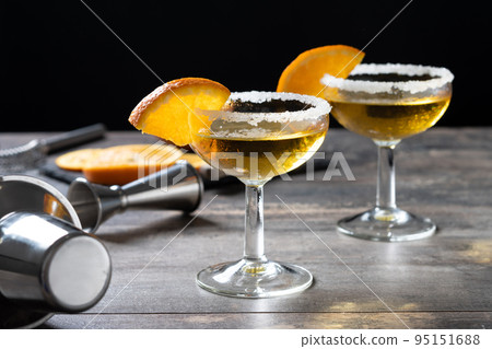 Sidecar cocktail with a sugar rim on wooden table Sidecar cocktail with a sugar rim on wooden table 95151688