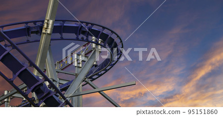 Attraction roller-coaster (switchback) against the background of a romantic evening sky Attraction roller-coaster (switchback) against the background of a romantic evening sky 95151860