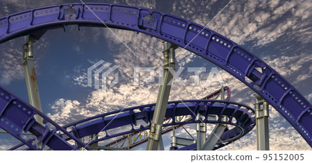 Attraction roller-coaster (switchback) against the background of a romantic evening sky 95152005