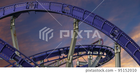 Attraction roller-coaster (switchback) against the background of a romantic evening sky 95152010
