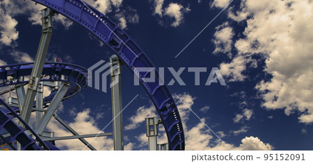 Attraction roller-coaster (switchback) against the background of a romantic evening sky Attraction roller-coaster (switchback) against the background of a romantic evening sky 95152091