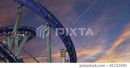 Attraction roller-coaster (switchback) against the background of a romantic evening sky 95152095