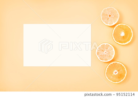 Gently yellow background with white paper sheet and citrus slices Gently yellow background with white paper sheet and citrus slices 95152114